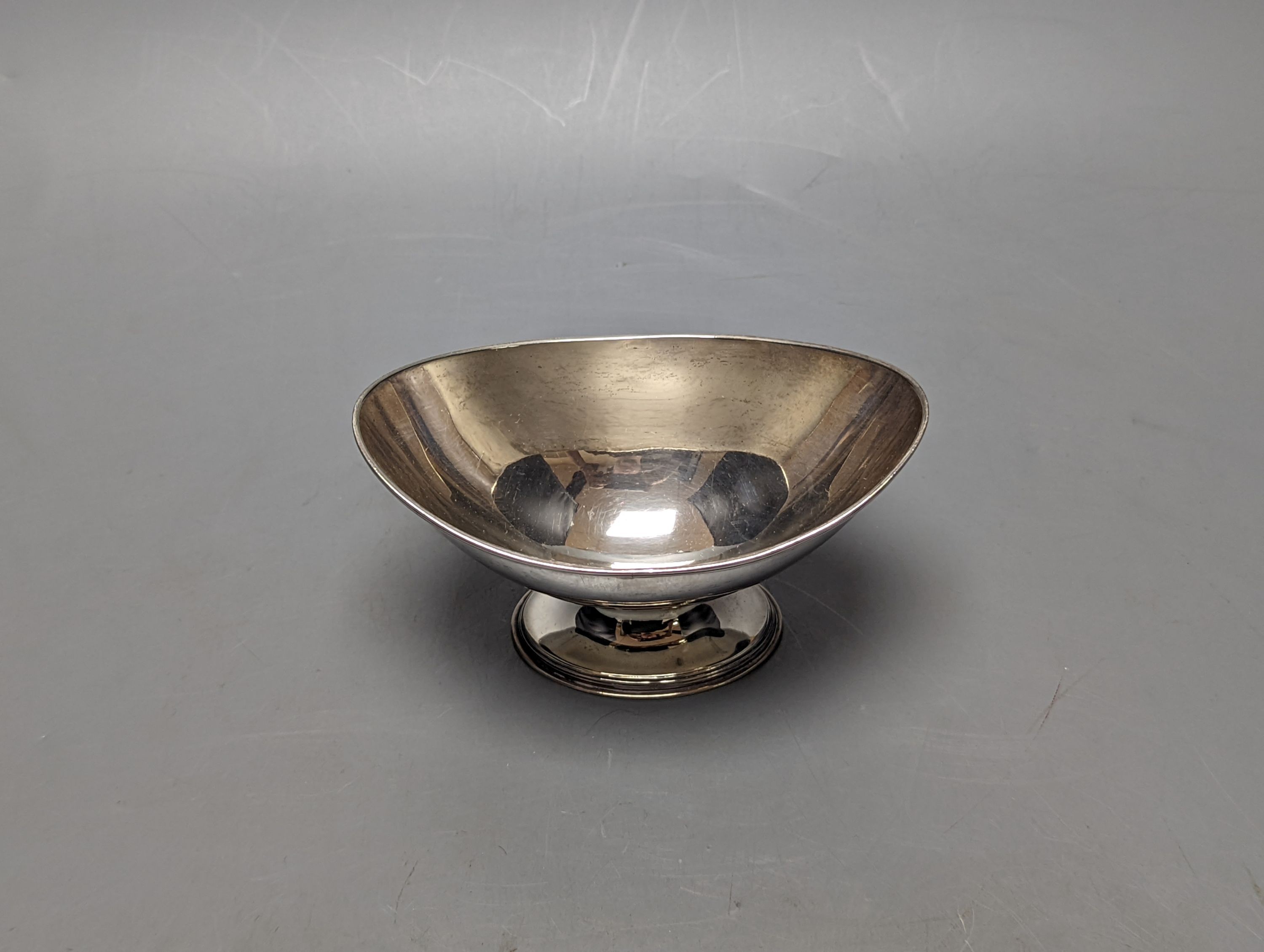 A George III silver sugar bowl, (ex basket), maker's mark double stamped, London, 1790, length 13.6cm